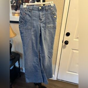Jennifer Lopez flare jeans with buttons inside pockets